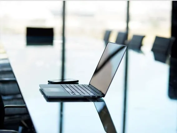 Computer sitting on conference room table 